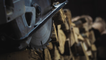 Wall Mural - Hand circular saw with piece of wood on workbench. Yellow electric tool on wood background. 