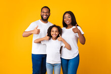 Happy Black Family Gesturing Thumbs Up And Smiling