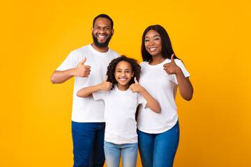 Wall Mural - Happy black family gesturing thumbs up and smiling