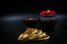 Gold Bangles On A Black Background