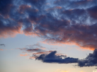 Dark clouds are illuminated by setting sun in spring sky