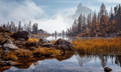 Fotobehang - Wonderful foggy autumn landscape. View on Federa Lake early in the morning at autumn during sunrise. Federa lake. Dolomites Alps. Amazing wild nature. Best famouse hiking locations. Great nature scene