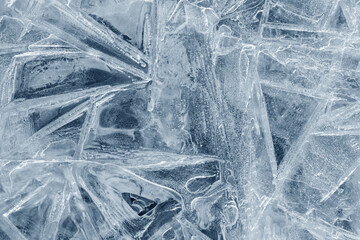 Wall Mural - Ice background texture. Frozen water in various geometric abstract shapes. Seasonal natural effect. Cold weather. The surface of the winter water reservoir.