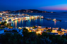 Beautiful Night View Of Mykonos, Greece, Ships, Port, Whitewashed Houses. Town Lights Up. Vacations, Leisure, Nightlife, Mediterranean Lifestyle