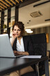© bnenin - Business manager reading report on laptop, portrait.