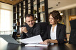 © bnenin - Two business people working together, portrait.