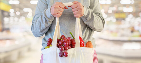 Wall Mural - Woman hold grocery shopping bag in supermarket