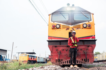 Wall Mural - African engineer   control a the train on railway with using tablet and talking by radio communication or walkie talkie