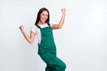 Wall Mural - Photo of astonished excited lady celebrate victory close eyes wear green overall isolated white color background