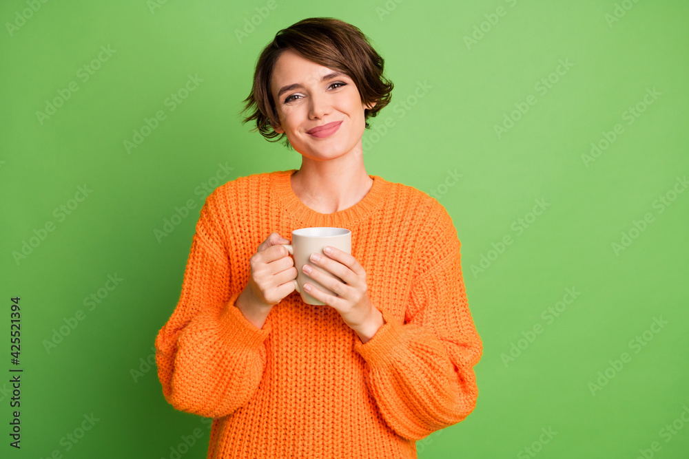 Photo of charming beautiful young girl hold coffee mug good mood cozy isolated on green color background - obrazy, fototapety, plakaty 