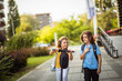 © liderina - Two school kids together outside.