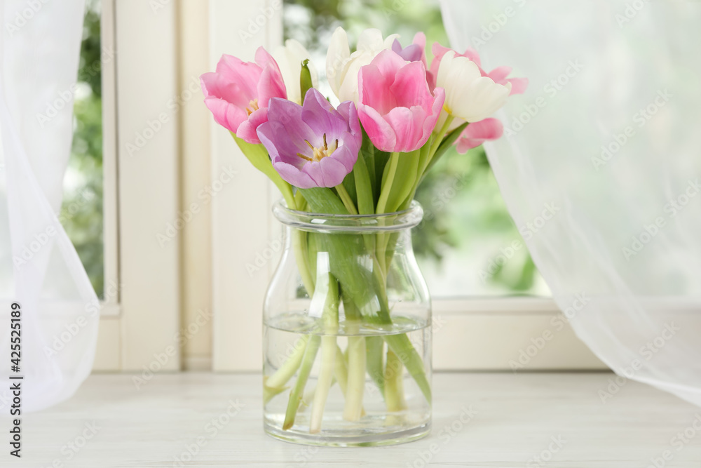 Beautiful fresh tulips on window sill indoors. Spring flowers - obrazy, fototapety, plakaty 