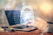 © peshkova - Multi exposure of man's hands holding and using a digital device and lock drawing. Security concept.