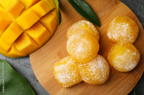 Obraz Dibond Delicious mango mochi on grey table, flat lay