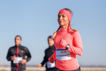 Wall Mural - Young sporty woman running marathon competition