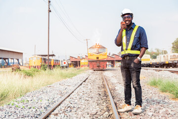 Wall Mural - African engineer   control a the train on railway with talking by radio communication or walkie talkie