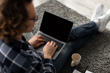 Poster - Back-View Of Guy Using Laptop With Blank Screen Sitting Indoor