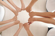 © DragonImages - Hands of volunteers of charity center making circle with clenched fists, expressing support and unity