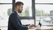 © LIGHTFIELD STUDIOS - side view of businessman in suit using laptop in cafe