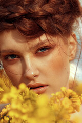 Wall Mural -  Young fashion model portrait with ginger hair and blue eyes in yellow rapeseed field