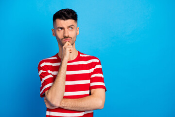 Poster - Photo of pensive minded guy look empty space hold hand chin think deep isolated on pastel blue color background