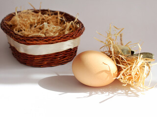 Eggs in a wicker basket. Close up of Easter eggs. Copy space for text. Wicker basket with two eggs. View from above. Isolated on white. Wooden wicker basket with eggs. Easter festival celebration