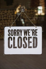 Sorry we are closed - text on shop window door. Coronavirus COVID-19 quarantine, lockdown concept.