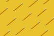 Yellow pencils pattern on yellow background.