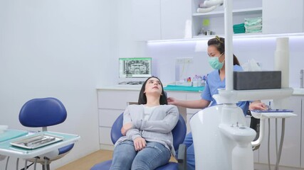 Wall Mural - Asian girl waiting to consult and ask for dental checkup with dentist.