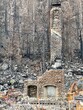The devastation of a forest fire leaves dream homes in utter ruins. 