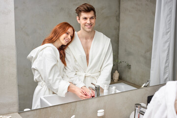 man and woman washing hands rubbing with soap for corona virus prevention, hygiene concept