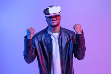 Wall Mural - Overjoyed Black Man In VR Glasses And Leather Jacket Playing Video Games