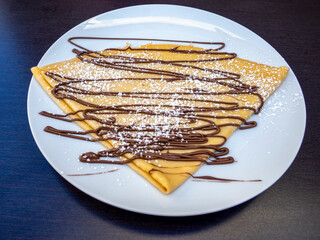 plate with crepes with chocolate cream