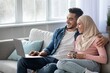 © Prostock-studio - Relaxed arab man and woman watching movie on laptop