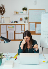 Young tired female professor having headache.
Teacher holding online class for e-learning students at home during COVID-19 pandemic period. Stressed woman take off glasses feel pain rub closed eyes