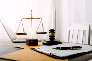 Business and lawyers discussing contract papers with brass scale on desk in office. Law, legal services, advice, justice and law concept picture with film grain effect