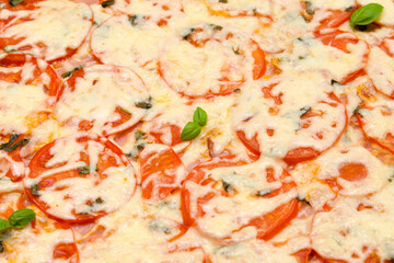 appetizing pizza with ham and cheese tomatoes and herbs flat top view closeup