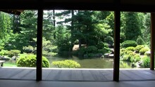 View Of Japanese Garden And Pond From Inside Japanese House With Walls Removed.