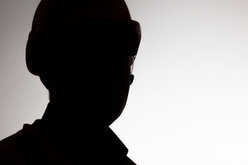 Wall Mural - face silhouette of builder in hard hat on white isolated background, male profession