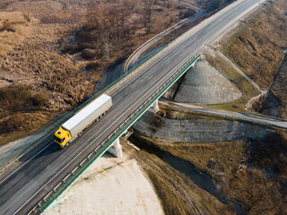 Wall Mural - Aerial Top View of White Truck with Cargo Semi Trailer Moving on