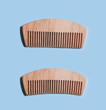 wooden comb on a colored background