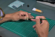 © Rafael - Man's hobby painting a small plastic figure.