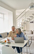 © insta_photos - Senior mature couple check bank loan documents using laptop at home. Middle aged old family read paper bills payments, calculating pension or taxes, planning retirement finances, household expenses.