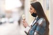 © StockPhotoPro - Woman eating ice cream in the street