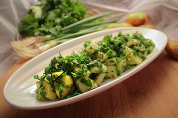 Potato salad with fresh onion and parsley. Close up