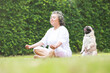 Asian Elderly woman practicing meditating yoga.