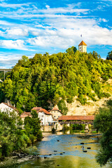 Wall Mural - The Sarine River with covered bridge in Fribourg, Switzerland