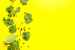 Fresh cilantro, lime and peppercorns on color background