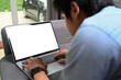 © Prathankarnpap - Close up view of casual man lying on comfortable sofa and working online with computer laptop.
