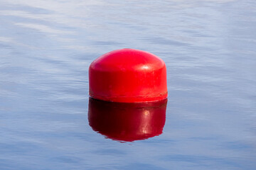 Poster - red buoy on the water. fencing on the water